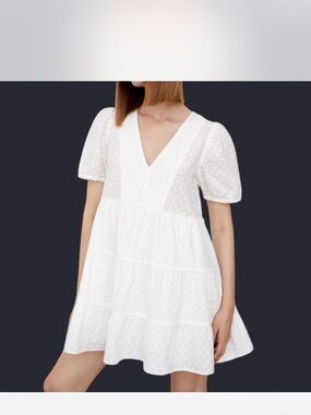 White cotton Zara dress size XS. Puffy sleeves and eyelet fabric design.